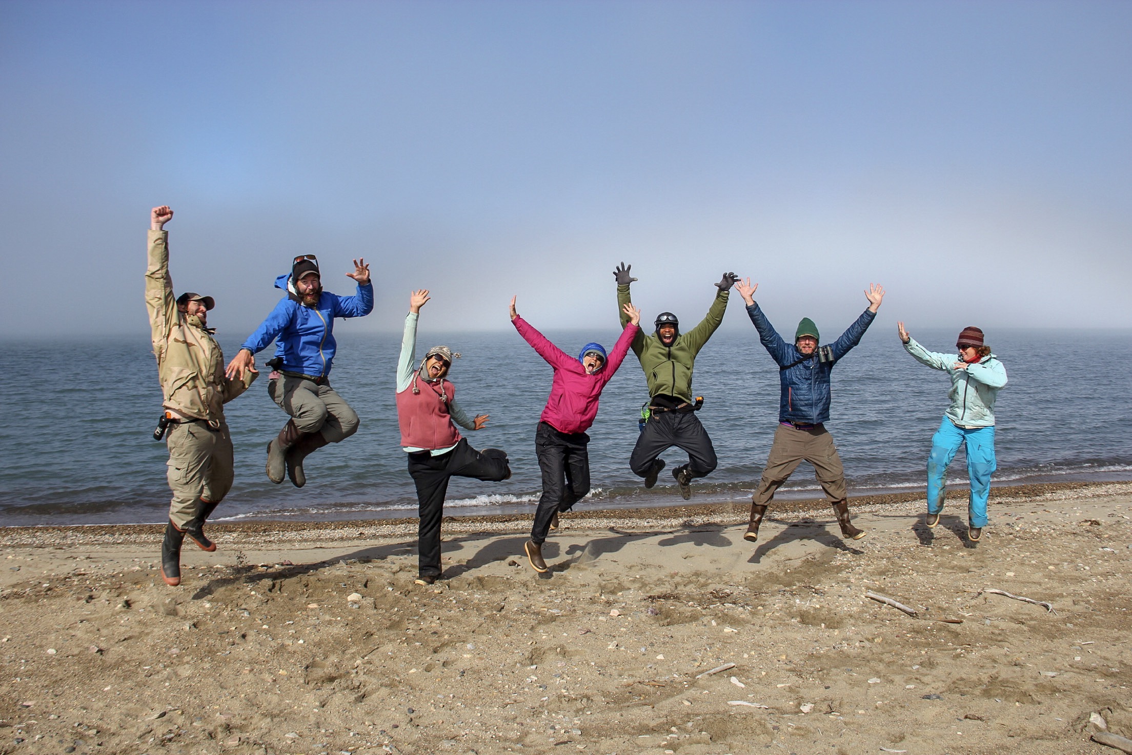 Sierra Club Military Outdoors participants jumping on the beach