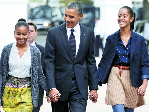 President Obama walking with his daughters