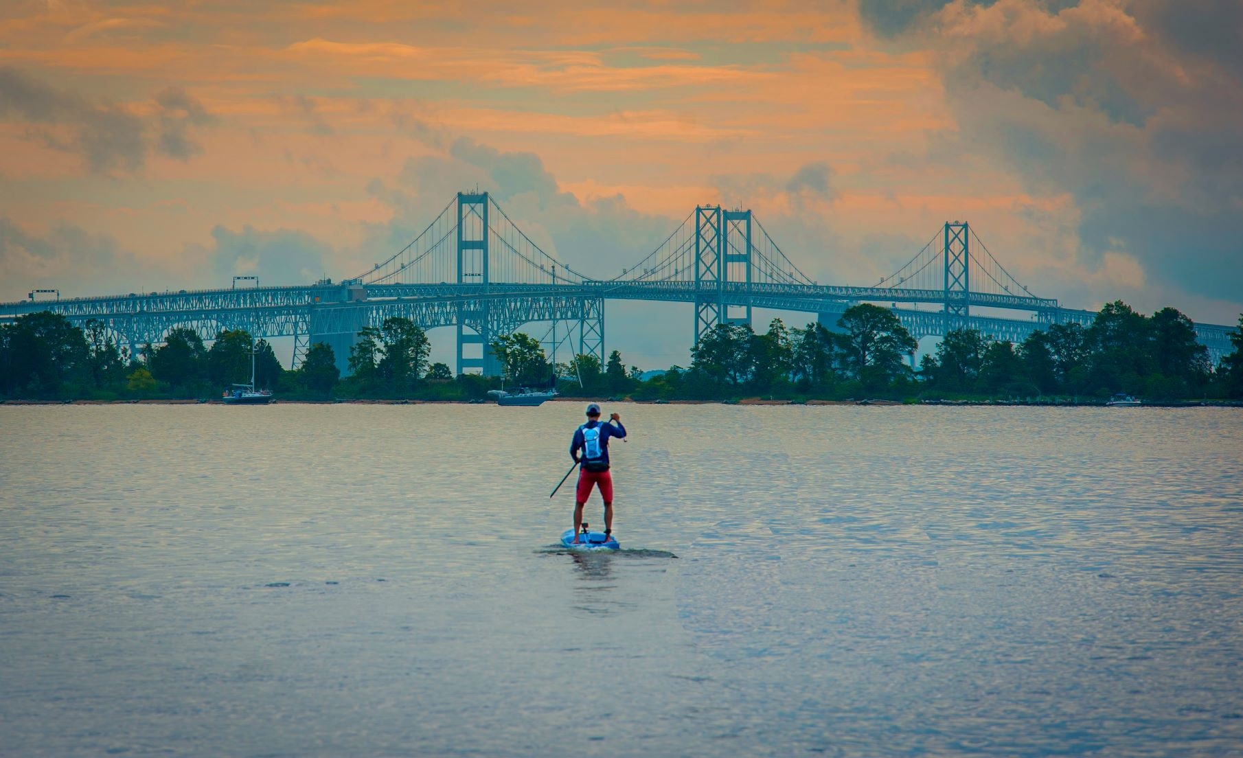 Man paddles in bay