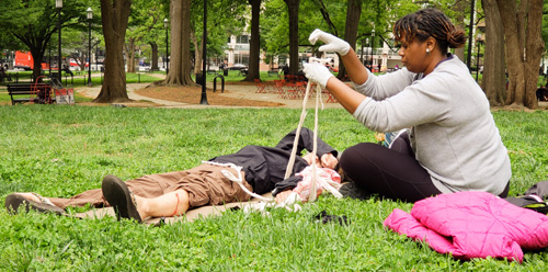 Students practicing first aid during class.  One learns a lot playing the role of patient, too.