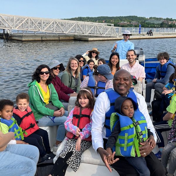 image of people in life jackets on a boat smiling.