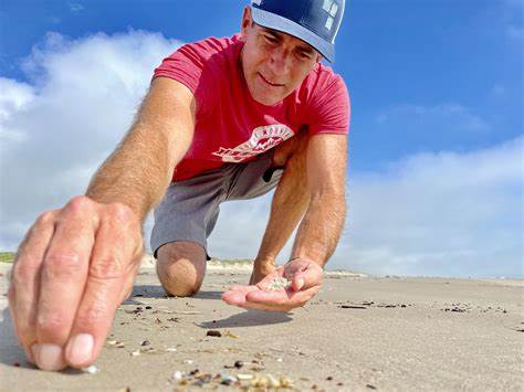 Man collecting nurdles on the beach