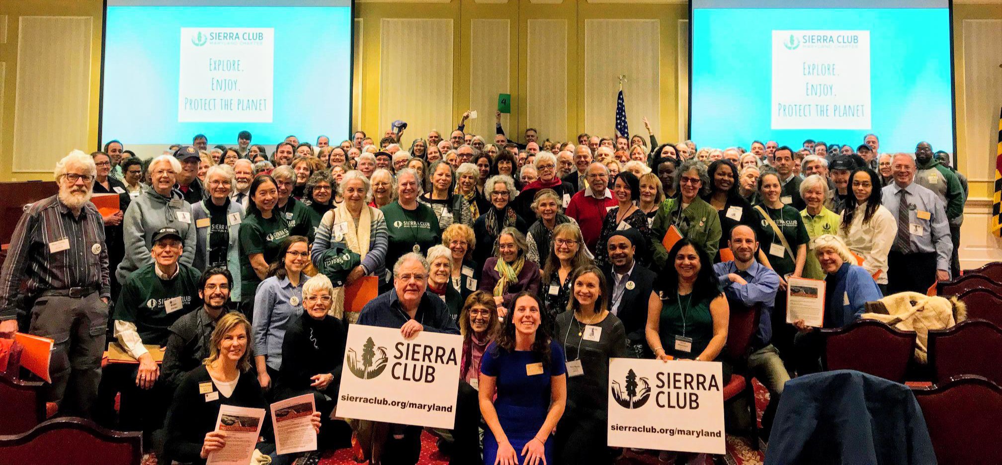 Hundreds of people gather for group photo with Sierra Club signs