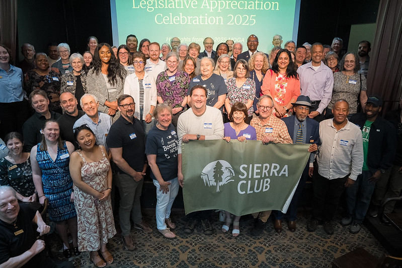 Group photo of people gathering at in front of a screen that says maryland sierra club legisaltive appreciation party