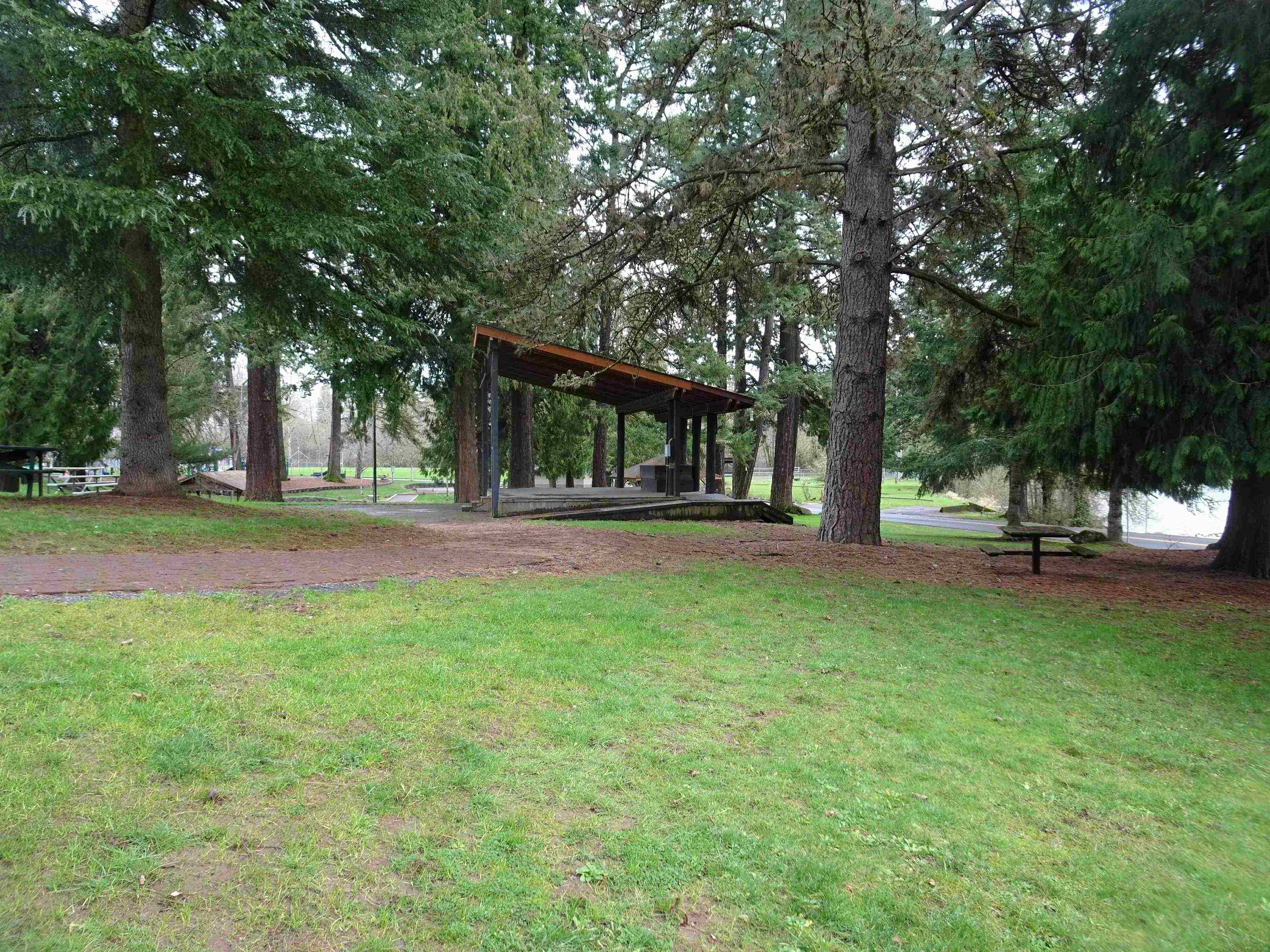 Gazebo in a park surrounded by trees.